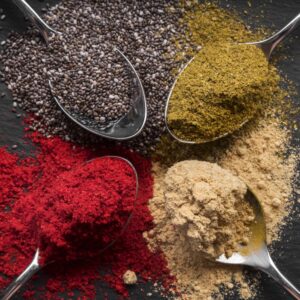 flat-lay-colorful-spices-black-background-min